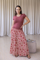 woman wearing a simple pink top and 100% cotton maxi skirt in gentle cream based floral print