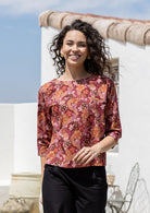 Model wears relaxed fit cotton top with 3/4 sleeves and round neckline in warm toned Japanese style print