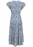 Blue and white floral print maxi dress with cap sleeves and tiered skirt,  back view.