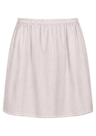 White slight A-line cotton slip skirt with elasticated waist and picot trim on hem, front view
