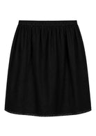Black slight A-line cotton slip skirt with elasticated waist and picot trim on hem, back view