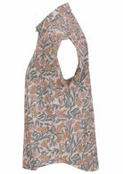 Side view of loose fit shirt style cotton top with collar in white based floral print