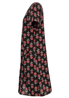 Side view of cotton dress with round neckline and short sleeves in black based floral print. 