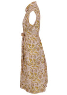 Side view of cream based floral print cotton dress with pockets.