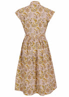 Back view of cream based floral print cotton cap sleeves dress.