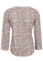 Back image of long sleeve cotton top with white based floral print.