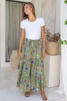 Model wearing 100% cotton maxi skirt with elasticised waist and drawstring in moss green based floral print.