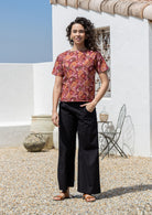Model wears 100% cotton Japanese style floral print top with plain black pants.