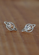 Sterling silver Saturn cutout design stud earrings with butterfly backs