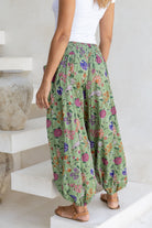 100% cotton floral green harem pants with flat wide waistband in front and elastic at the back.