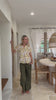 Video of a woman poses in relaxed fit cotton short sleeve top with rolled cuffs sleeves, collar and V neckline.