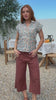 Video of a woman wearing a slim fit button up shirt with shell buttons, structured collar and folded cuff sleeves