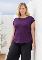Woman wearing a soft flattering fit purple rayon jersey t-shirt.