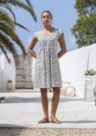 Woman wearing a 100% cotton Short-sleeve knee-length dress in dune floral print with pintuck front. 