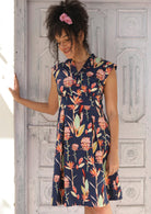 Woman wearing Floral V-neck Cotton Short Sleeve Dress, tailored bodice with cap sleeve empire waistline a-line skirt with box pleats
