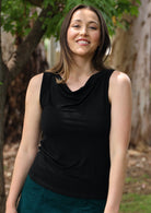 Woman wearing black cowl neck rayon singlet top