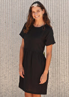 Smiling woman in short  sleeve cotton blck dress
