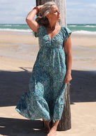 Model wearing 100 percent cotton maxi dress with short sleeves and drawstring waist.