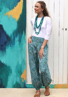 Model wears 100% cotton pants with wide elastic waistband and hand in deep pocket.