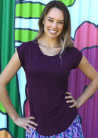 Woman wearing a soft flattering fit purple rayon jersey t-shirt.